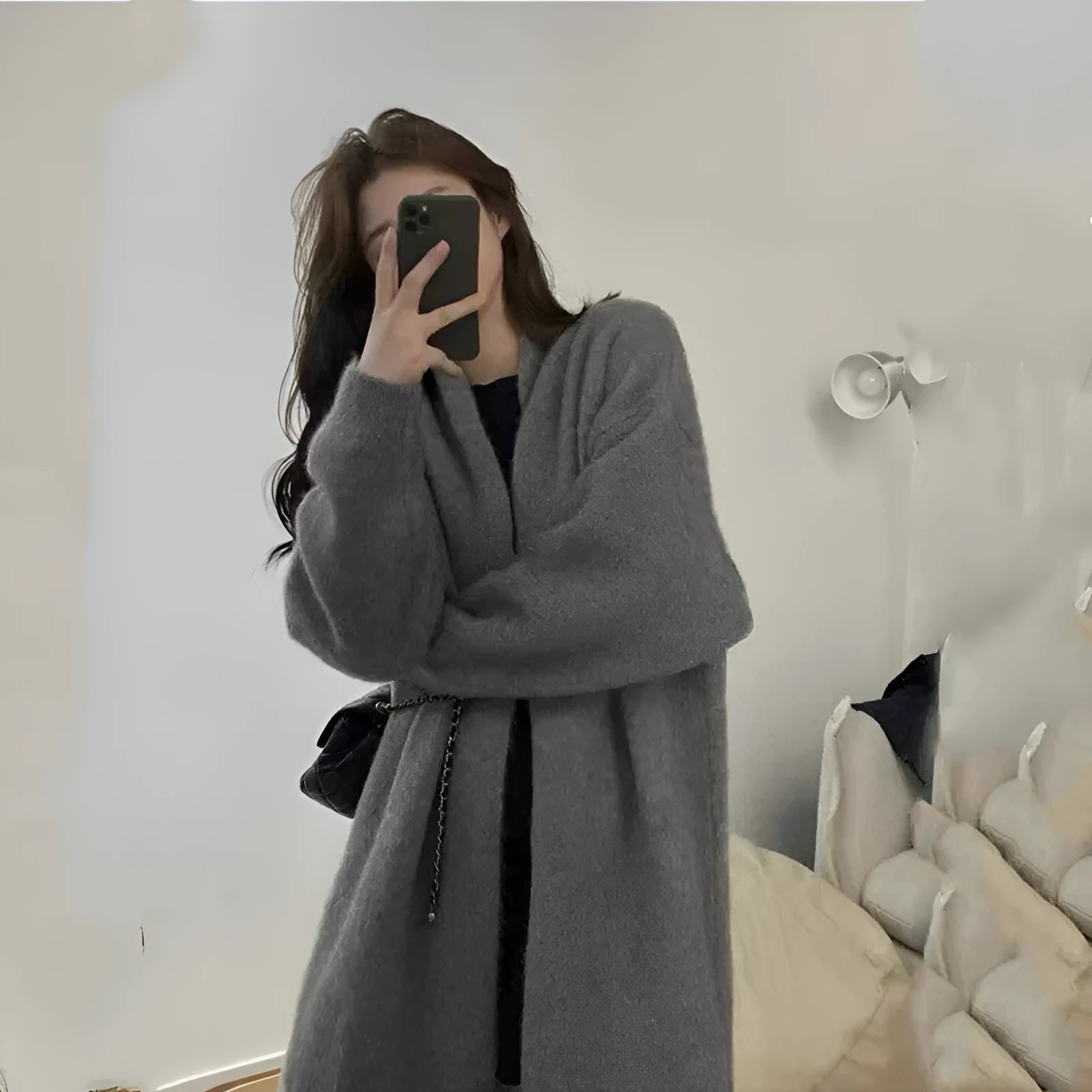 A loose, thick-knit women's cardigan in chenille fabric showing a 3D textured pattern.