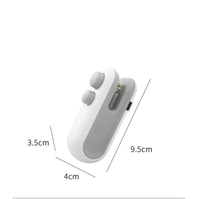 White handheld vacuum sealing machine with USB charging port and magnetic back for chip bags