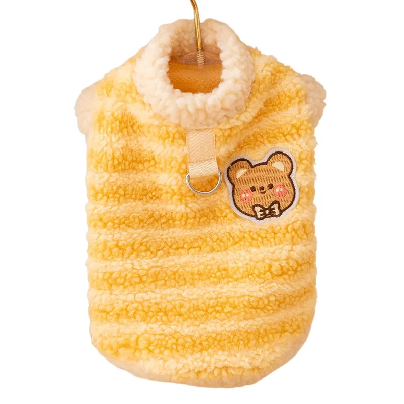 Blue striped lambskin fleece dog coat with drawstring and leash ring on a small dog against a neutral background