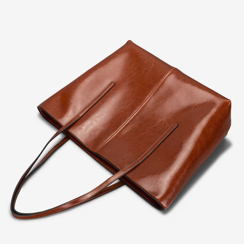 Women's soft cowhide leather shoulder bag in retro brown colour showing external slit pocket and single strap.