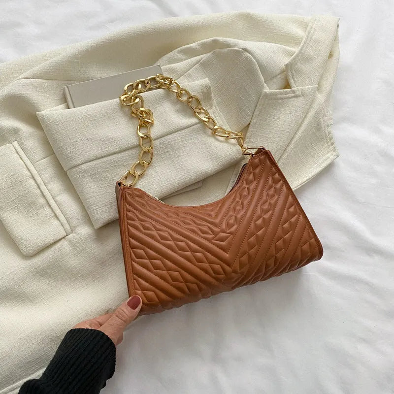 Brown pleated chain baguette shoulder bag showing vertical square shape and soft carry handle