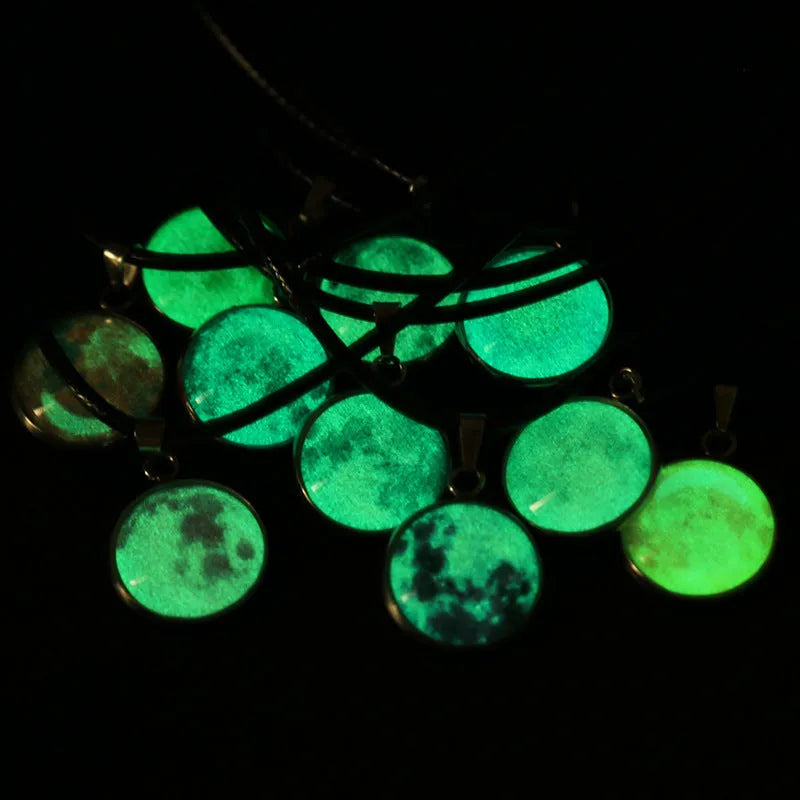 Luminous moon and constellation glass pendant on a silver alloy necklace chain with an extension piece.
