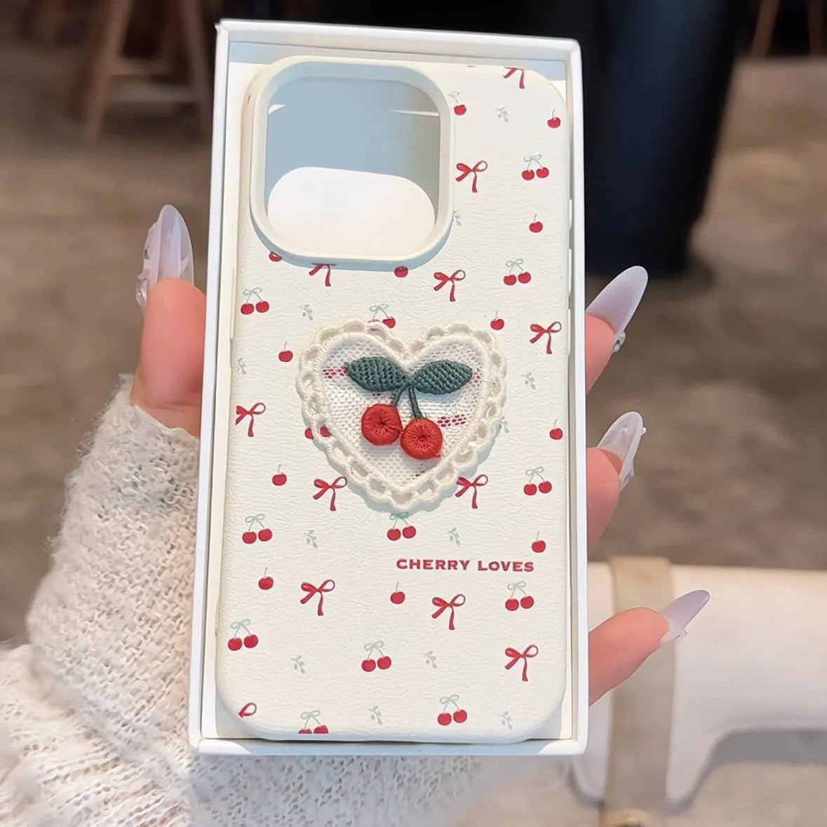 Cherry embroidered silicone iPhone case in litchi pattern white with three-dimensional raised embroidery design