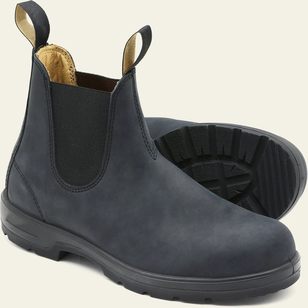 Vintage brown unisex Chelsea boots with round toe and low horseshoe heel on a wooden floor.