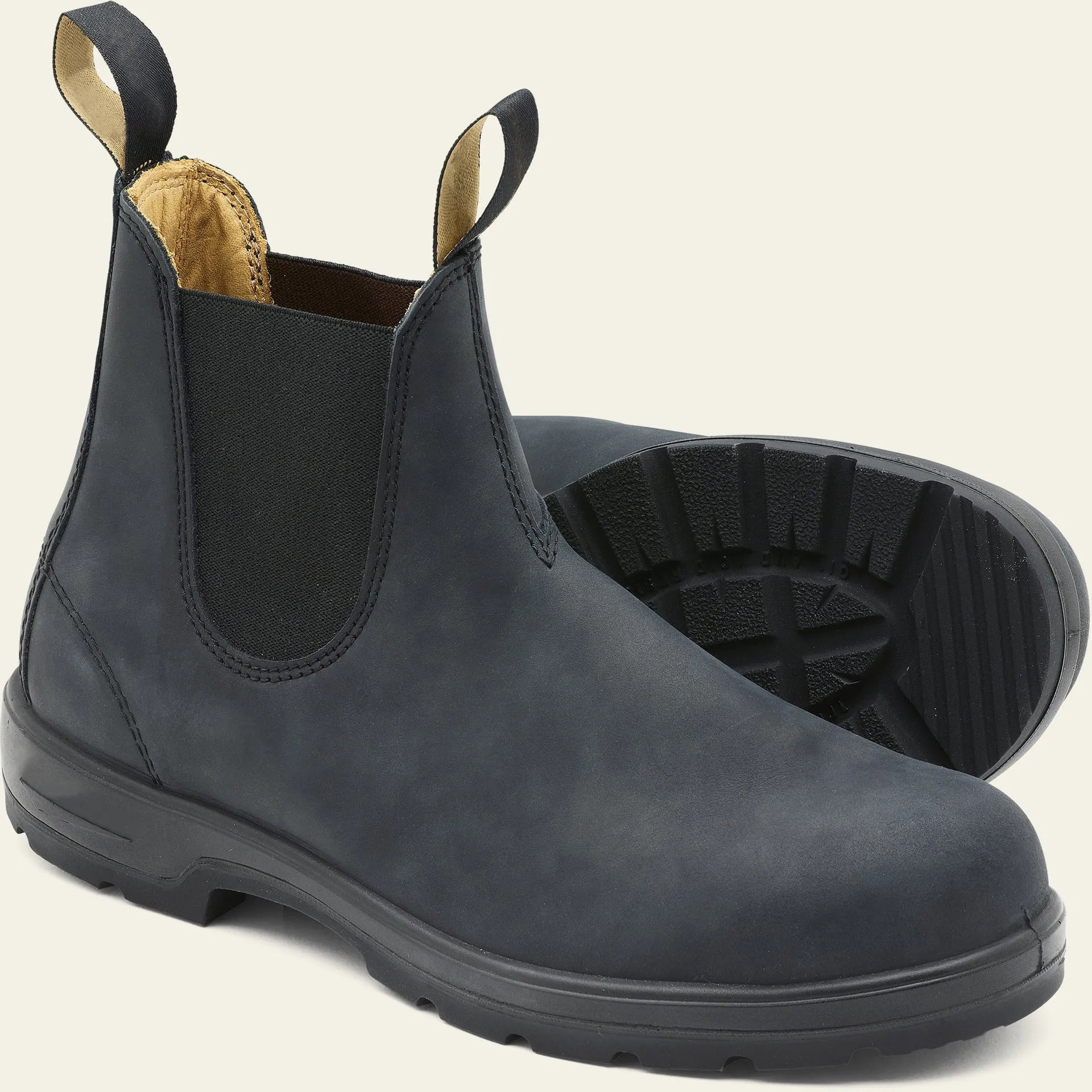 Vintage brown unisex Chelsea boots with round toe and low horseshoe heel on a wooden floor.