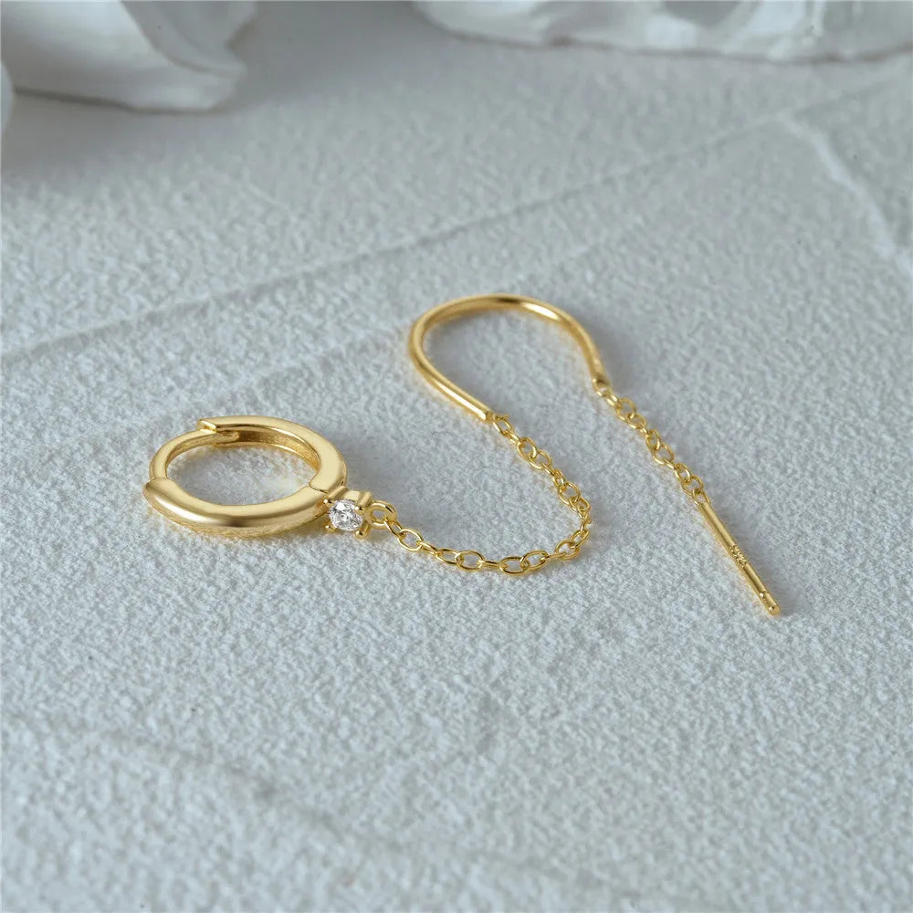 S925 sterling silver stud earring with a diamond-shaped flower, dangling tassel, and chain detail in a golden colour.
