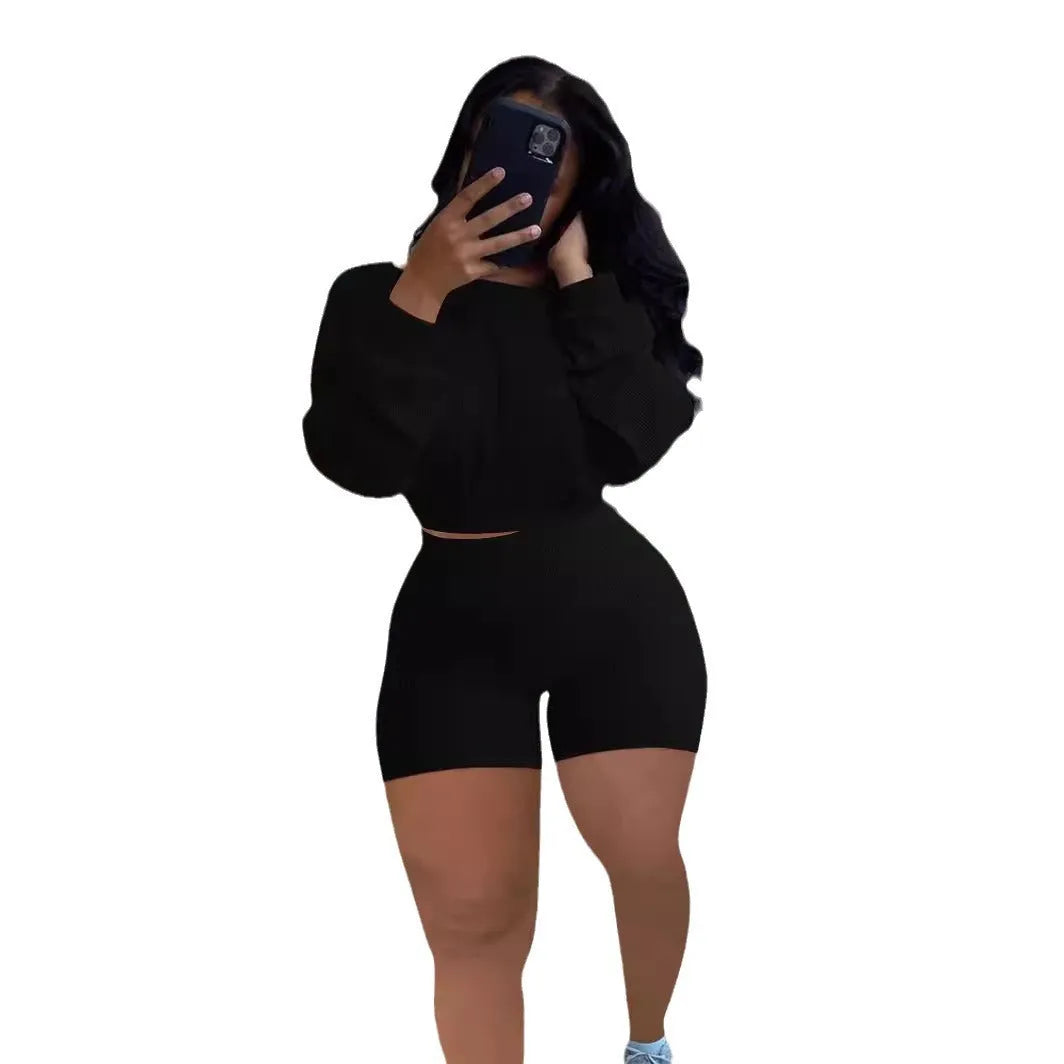 Off-the-shoulder long sleeve top and shorts two-piece set in a solid colour with a sunken stripe pattern.