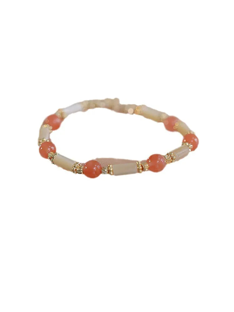 Women's Hetian jade bracelet with bamboo joint design in jade green and red colour options.