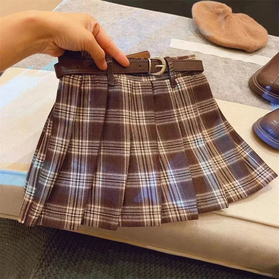 Girls red and black plaid A-line pleated skirt made from cotton blend fabric.