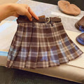 Girls red and black plaid A-line pleated skirt made from cotton blend fabric.