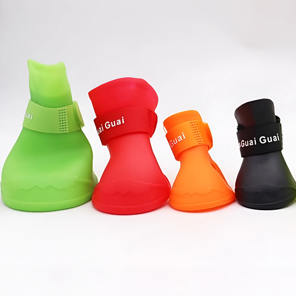 Set of four anti-slip pet rain shoes in various colours with rubber soles for waterproof dog paw protection.