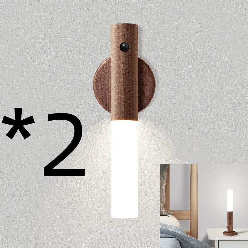 Smart sensor LED desk lamp in solid wood and acrylic, showing compact design beside a charging cable.