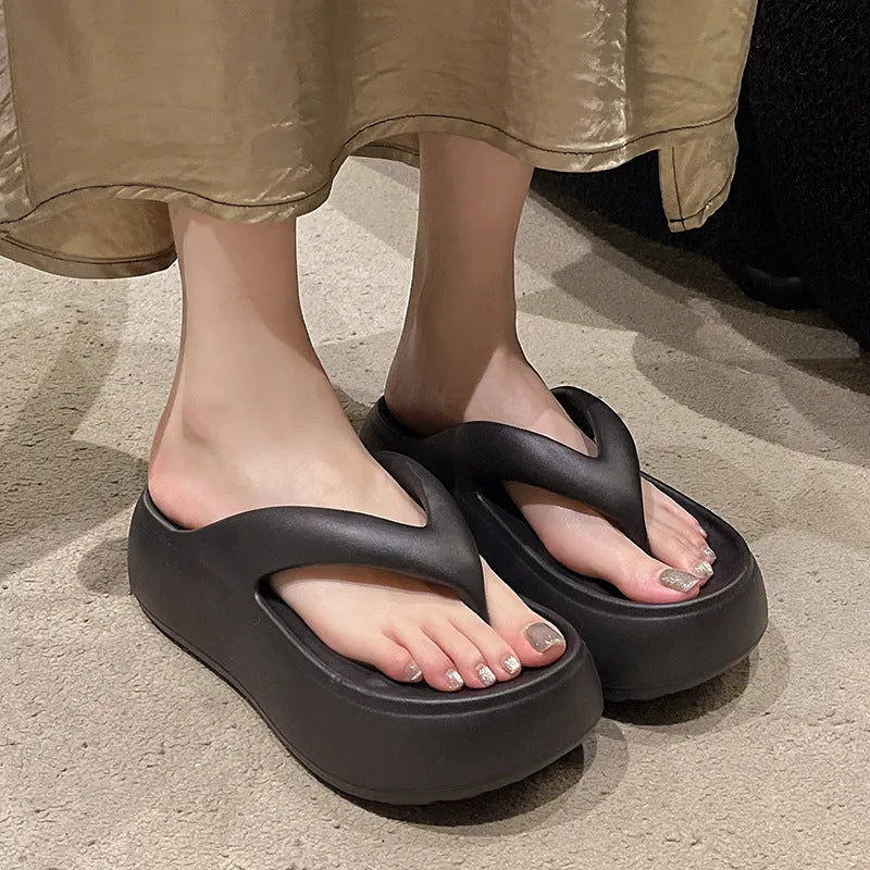 Women's thick-soled height increasing flip-flops in black with herringbone EVA upper