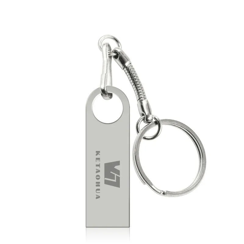 Silver metal car-shaped USB flash drive on a white background, showing its compact size and USB connector.