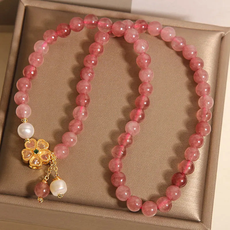 Women's double ring bracelet with a strawberry quartz twin four-leaf clover design.