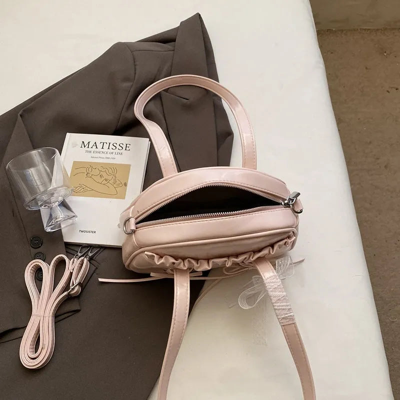 Women's casual PU leather shoulder handbag with a bandage bow detail, shown in beige colour.