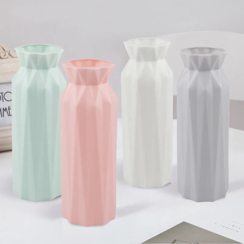 A green drop-resistant plastic melamine vase with a wide 7.2cm base on a wooden table.