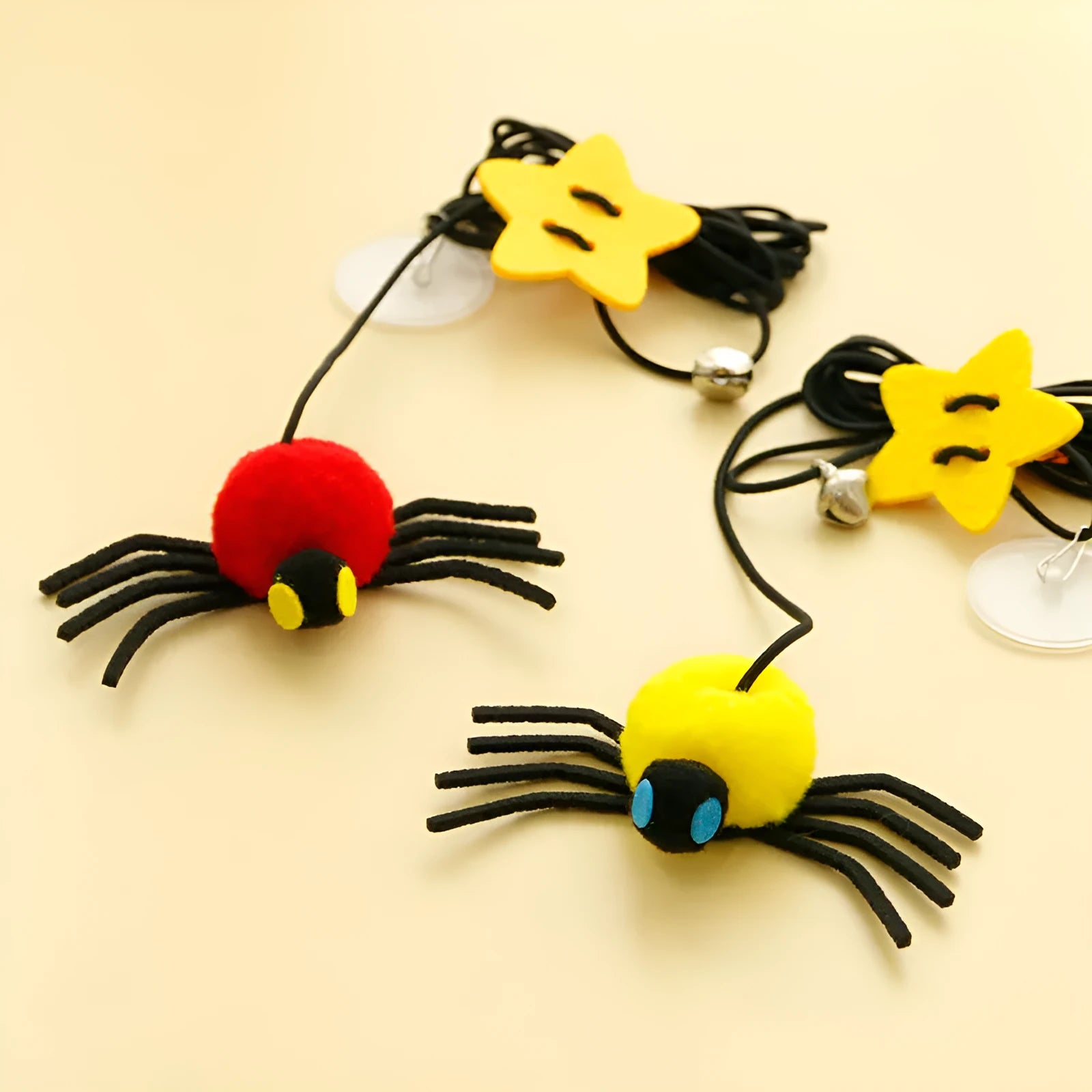Red hanging door cat toy with elastic rope, feather, bell, and spider attachment