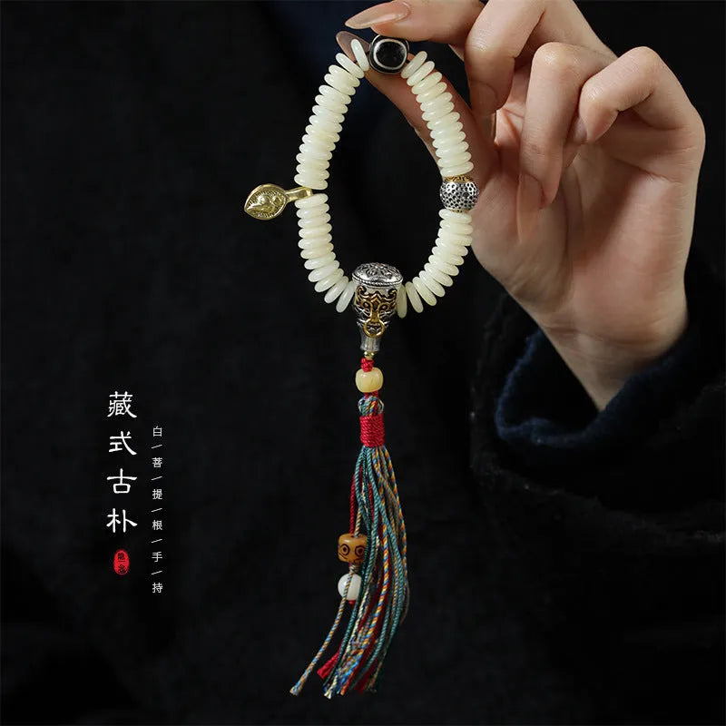 A white Bodhi seed bracelet shown in both a looped wrist style and a straight handheld style.