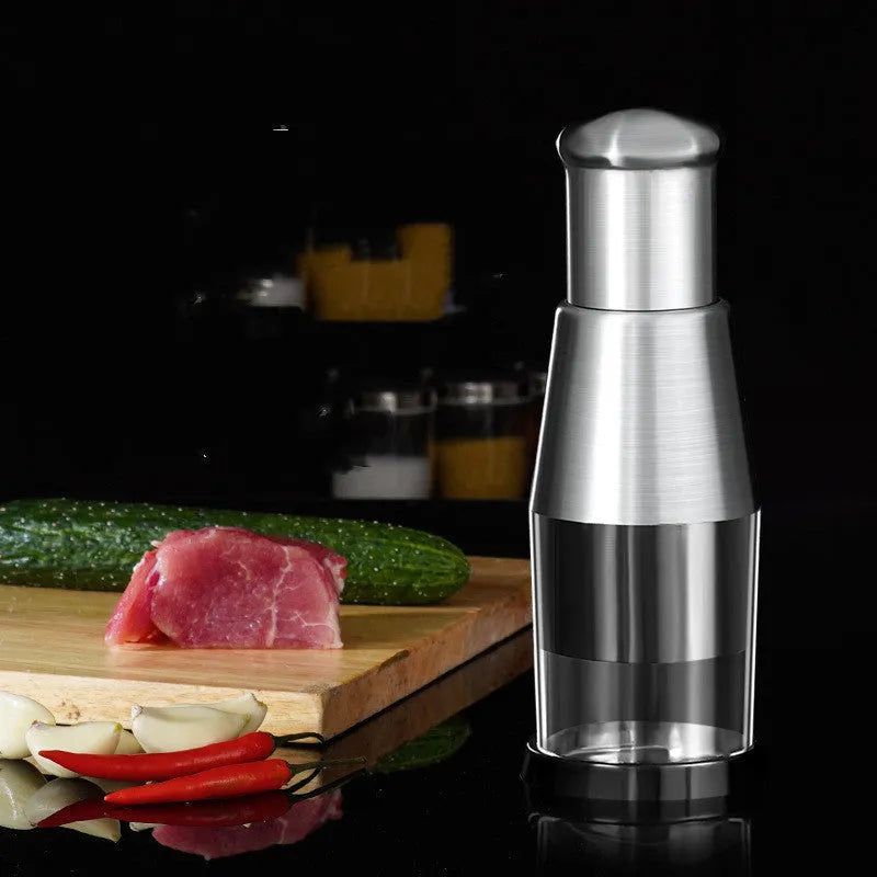 Manual garlic press and onion chopper kitchen gadget with stainless steel blades, shown in modern simplicity style.